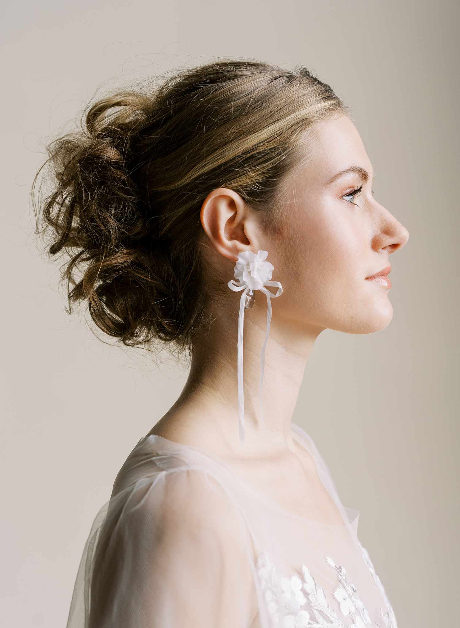 Clean white hand sculpted bridal flower earrings with teardrop clear crystal and silk bows. Wedding earrings by Twigs and Honey