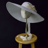 wide white straw hat with silk flowers and bow, twigs and honey