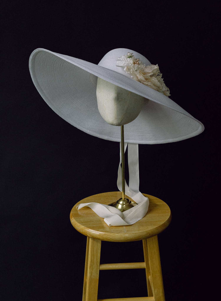 wide white straw hat with silk flowers and bow, twigs and honey