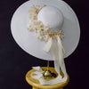 wide white straw hat with silk flowers and bow, twigs and honey