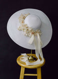 wide white straw hat with silk flowers and bow, twigs and honey