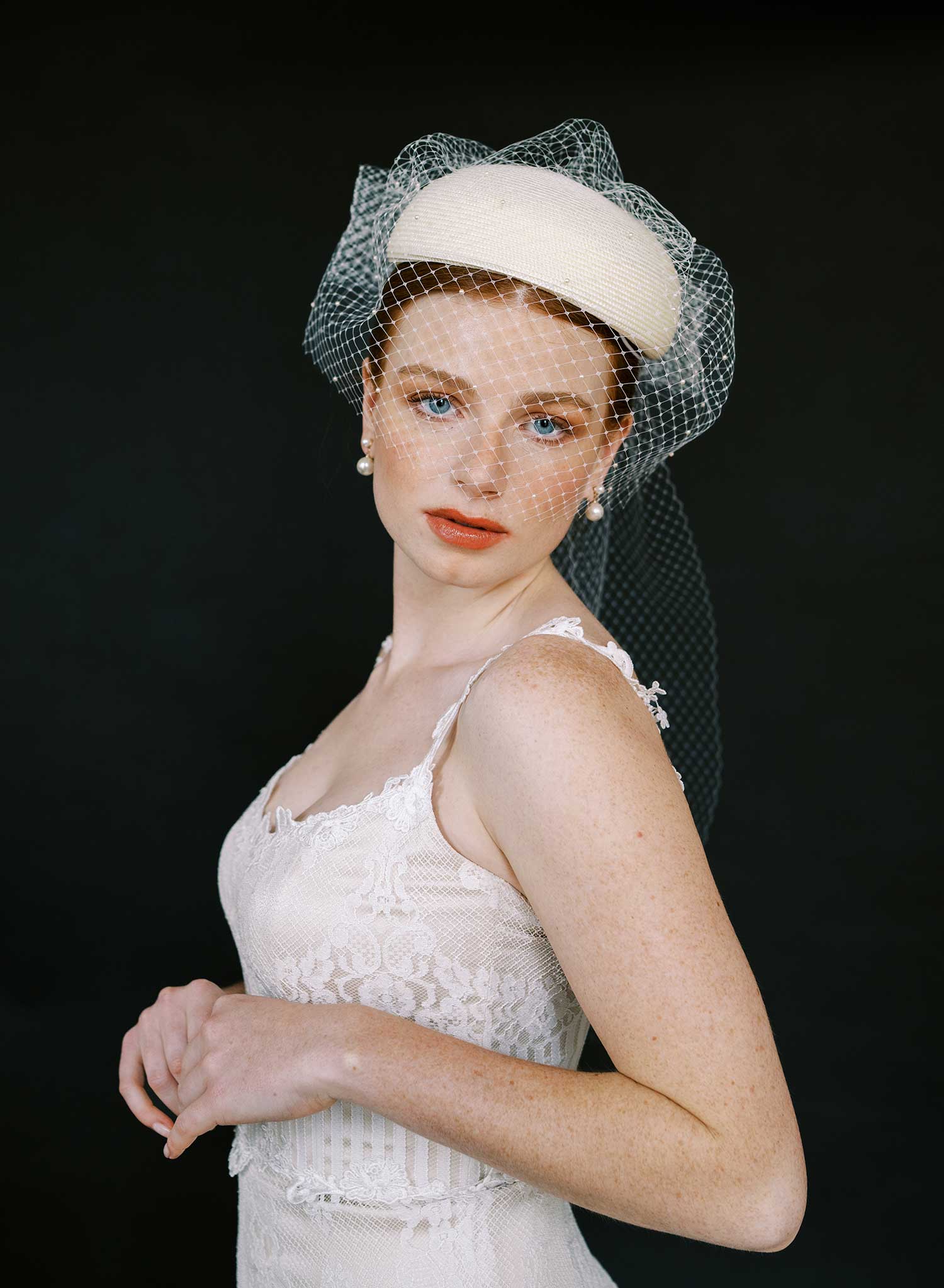 Straw pillbox bridal hat with birdcage veil
